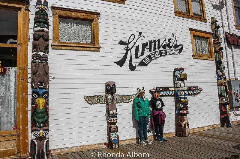 Totem poles outside a shop on Broadway in Alaska