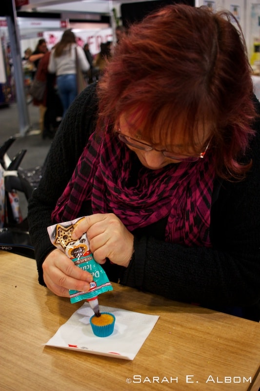 Decorating cupcakes at the XXX stall at the Auckland Food Show