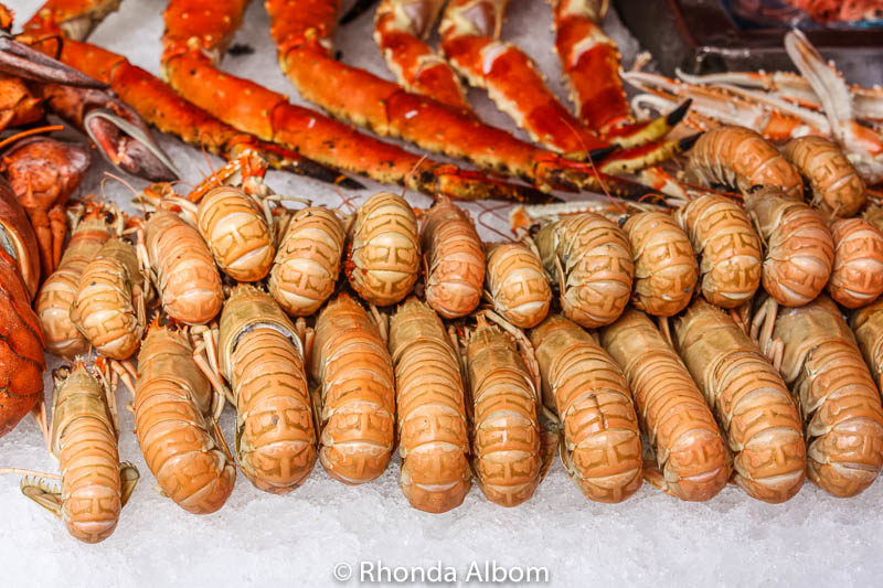 Shrimp and crab legs on display at a fish market in Bergen, Norway