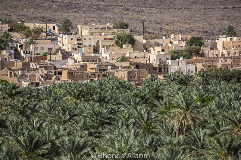 Al Hajar mountains are an interesting mix of green palms and desert structures.