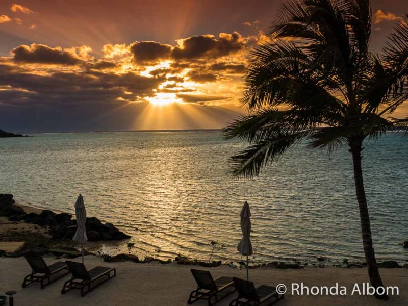 Deep orange sunrise over the ocean and seen from a Rarotonga beach resort