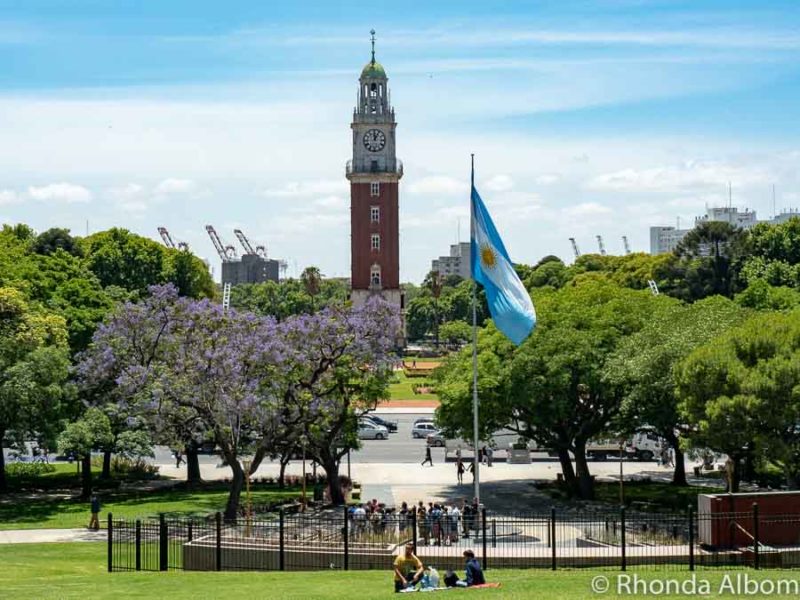 The flag of Argentina in Buenos Aires with the British-style clock tower in the background as part of our Argentina travel guide