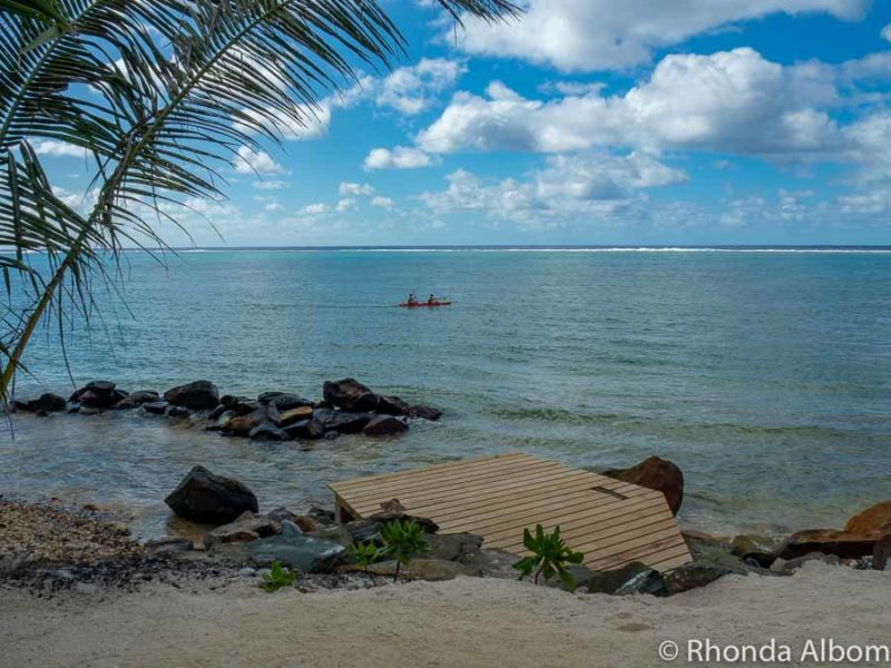 Sand, small boardwalk, and a rocky shore at a resort on Rarotonga in the Cook Islands