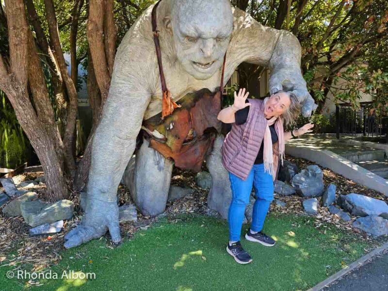 Rhonda Albom with Troll in front of Weta Workshop, in Wellington New Zealand