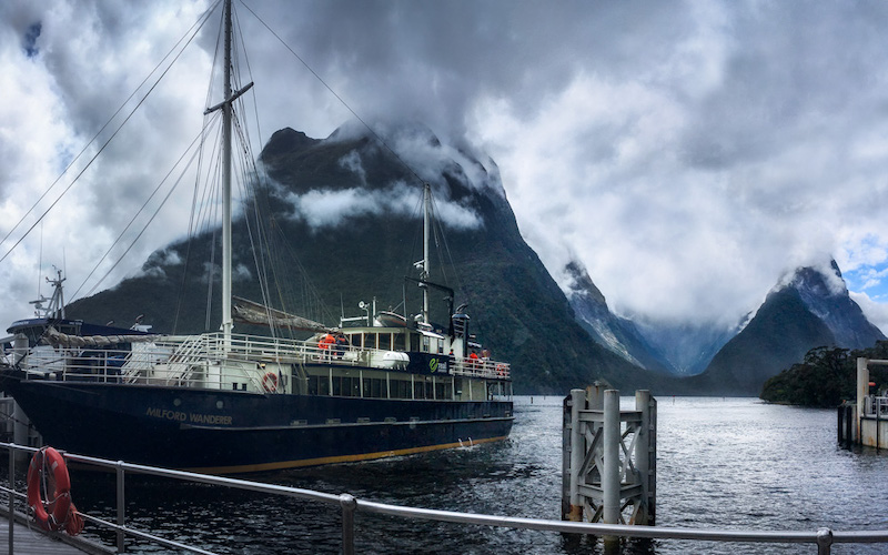 Milford Sound overnight cruise boat at Southern Discoveries docks cloudy Milford Sound