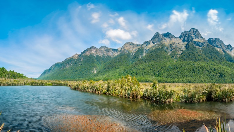 Mirror Lake with the mountain range in the background in Fiordland National Park, New Zealand, South Island.