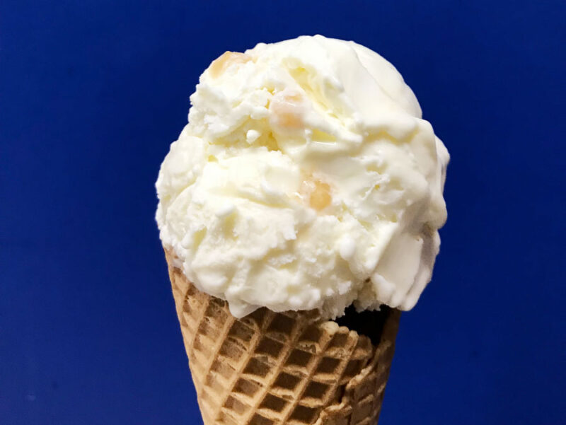 A scoop of Hokey Pokey ice cream on a cone.